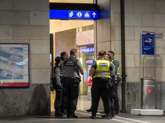 Geneva Police officers and Railway Police officers are seen at an the entrance to Geneva C