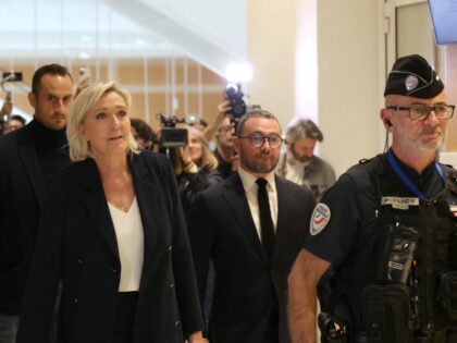 French far-right Rassemblement National (RN) Member of Parliament Marine Le Pen (C) leaves