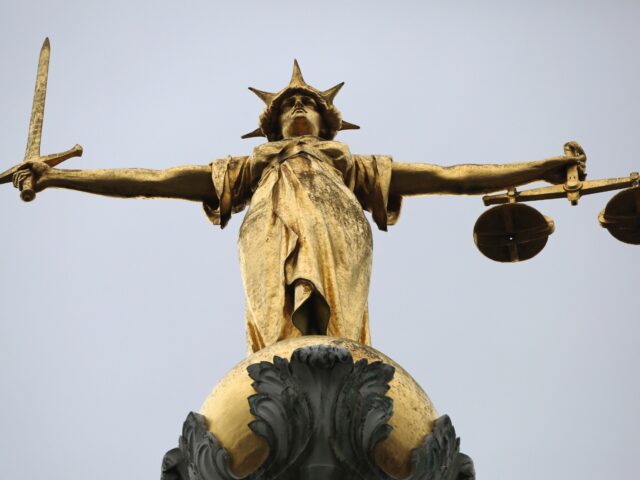 LONDON, ENGLAND - FEBRUARY 16: A statue of the scales of justice stands above the Old Bail