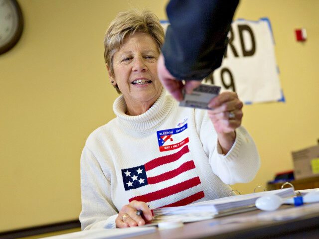 A poll worker checks the identification of a resident at polling location during the presi