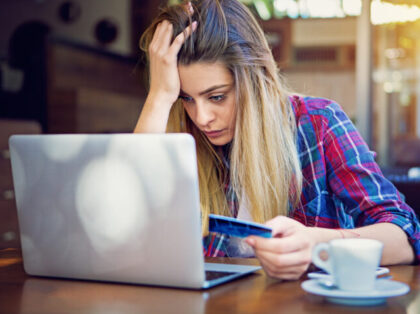 Young girl have problems with her credit card till shopping online