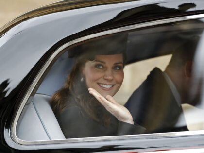 Britain's Catherine, Duchess of Cambridge waves from a car as she and Britain's Prince Wil