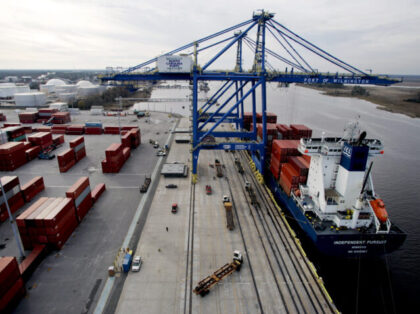 A gantry crane unloads shipping containers from the cargo ship Independent Pursuit at the