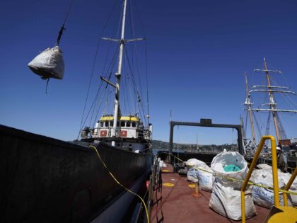 Plastics and other debris from the North Pacific Gyre are unloaded from the Ocean Voyages