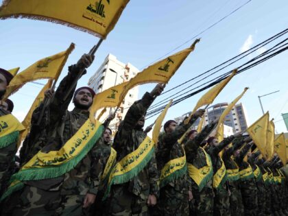 Hezbollah members march during the funeral procession of their comrades who were killed in