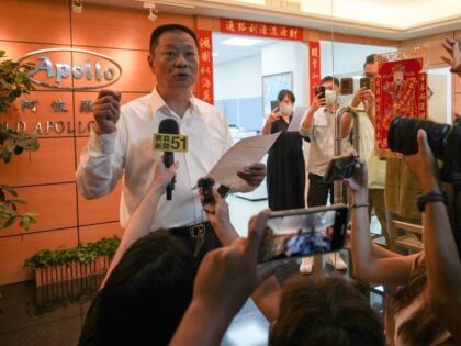 Hsu Ching-kuang (L), head of Taiwanese company Gold Apollo, speaks to the media outside th