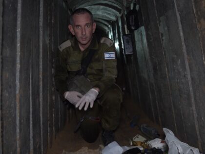 IDF Spokesman Rear Admiral Daniel Hagari kneels in the tunnel where Hamas murdered six Isr