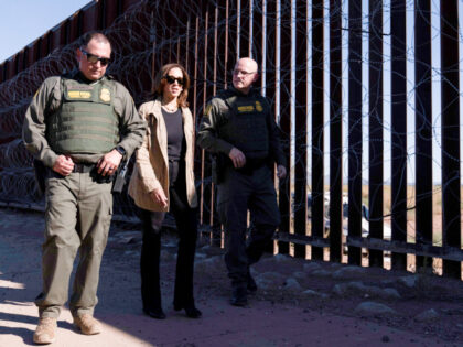 Democratic presidential nominee Vice President Kamala Harris, center, talks with John Modl