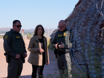 Democratic presidential nominee Vice President Kamala Harris talks with John Modlin, the c