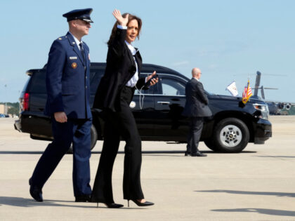 Democratic presidential nominee Vice President Kamala Harris waves as she boards Air Force