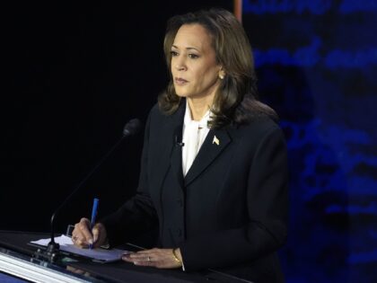 Democratic presidential nominee Vice President Kamala Harris takes notes during a presiden