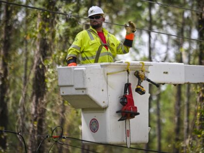 Workers attempt to restore power lines after Hurricane Helene made landfall in Keaton Beac