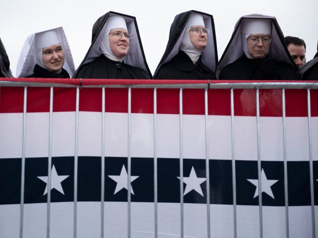 TOPSHOT - Little Sisters of the Poor wait for US President Donald Trump to speak during a