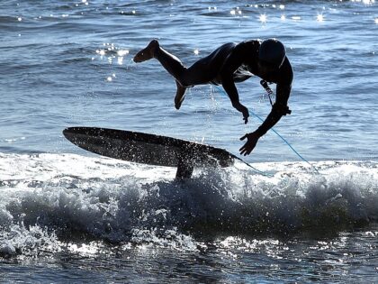 MALIBU, CA -JANUARY 5, 2022: Matt Hamilton, left, takes a tumble as he and friend, Josh Le