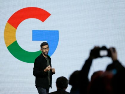 Sundar Pichai speaks in front of a Google logo