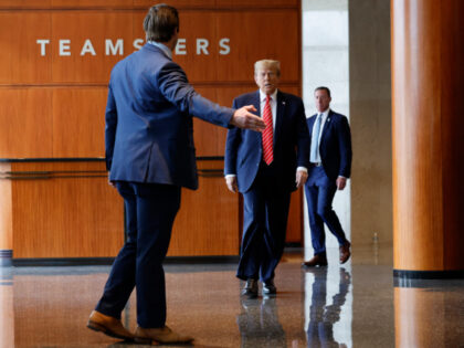 Republican presidential candidate and former U.S. President Donald Trump (C) walks to a po