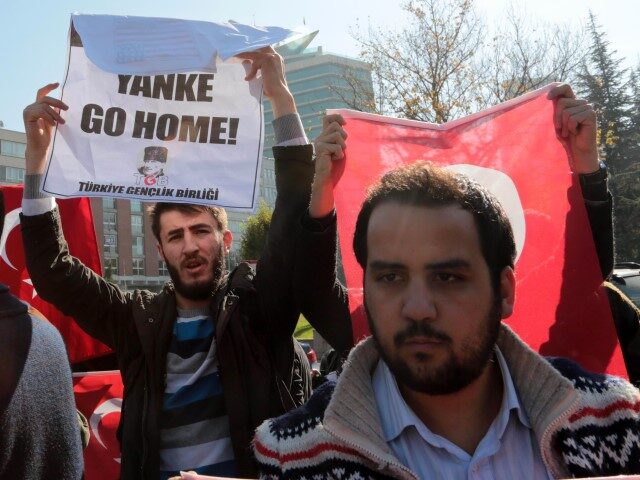 Members of the Youth Union of Turkey (Turkiye Genclik Birligi, TGB) hold signs and Turkish