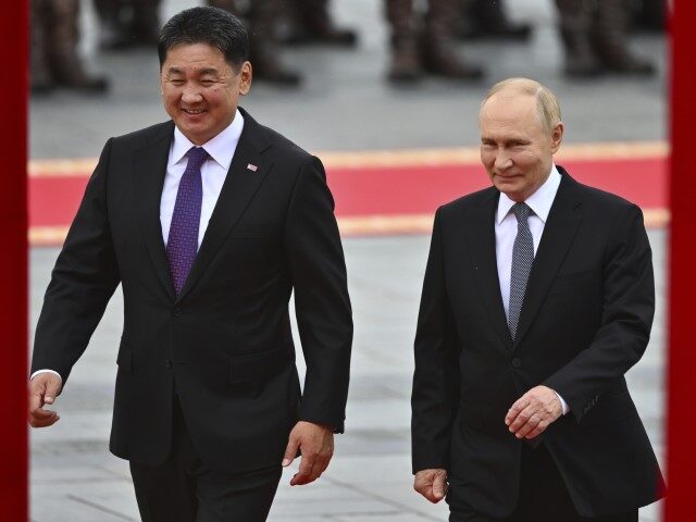 Russian President Vladimir Putin, right, walks with Mongolian President Ukhnaagiin Khurels