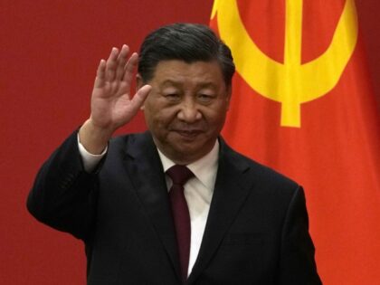 Chinese President Xi Jinping waves at an event to introduce new members of the Politburo S