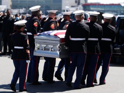 An Honor Guard carried the casket of Sgt. Johanny Rosario Pichardo to a hearse in Boston o