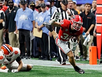 ATLANTA, GA - AUGUST 31: Georgia Bulldogs running back Cash Jones (32) breaks a tackle aga