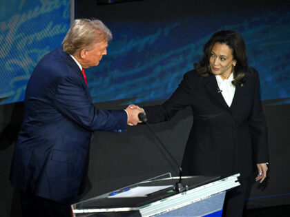 US Vice President and Democratic presidential candidate Kamala Harris (R) shakes hands wit