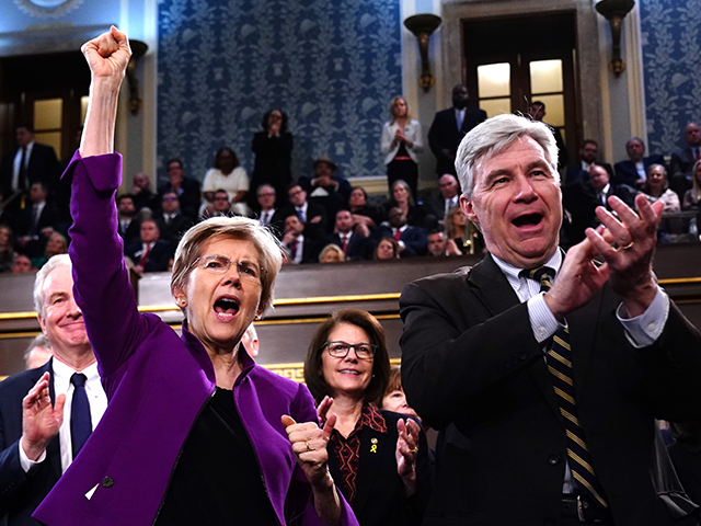 Democratic Senators Elizabeth Warren (D-MA), left, and Sheldon Whitehouse (D-RI) cheer dur