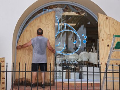 ARPON SPRINGS, FLORIDA - SEPTEMBER 25: Gary Lush places plywood against a window as he pre