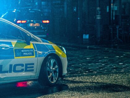 a police car parked on the side of the road, London