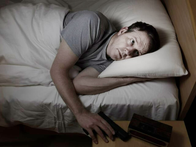 man in bed reaching for gun (1)