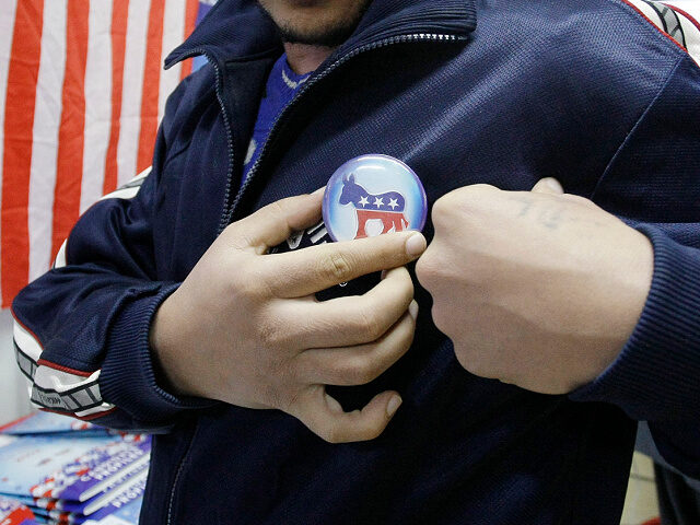 An Afghan journalist pins a badge representing U.S. Democrat during a U.S. election event