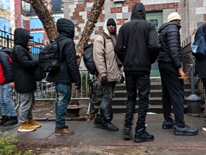 NEW YORK, NEW YORK - JANUARY 24: People, mostly newly arrived migrants, receive an afterno