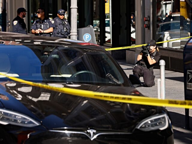 Police officers secure the area and investigate the scene of a shooting at Union Square in