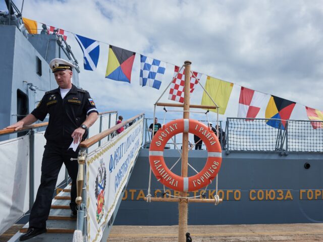 A member of the Russian navy disembarks the Russian frigate Admiral Gorshkov, ahead of nav