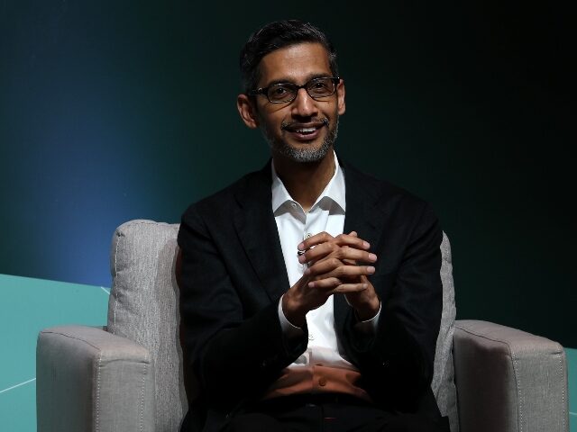 sundar pichai with hands clasped together