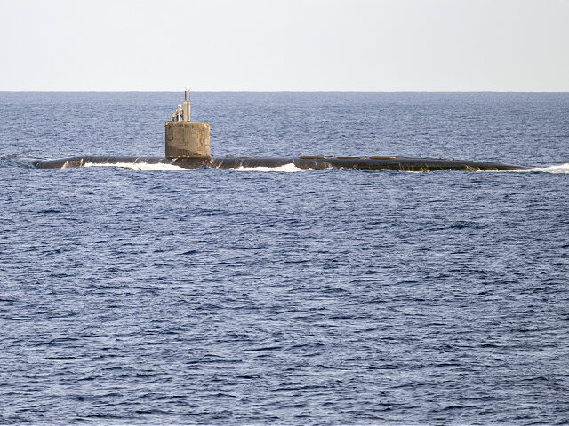 31 July 2024, USA, Honolulu: A submarine sails near the naval port of Pearl Harbor during