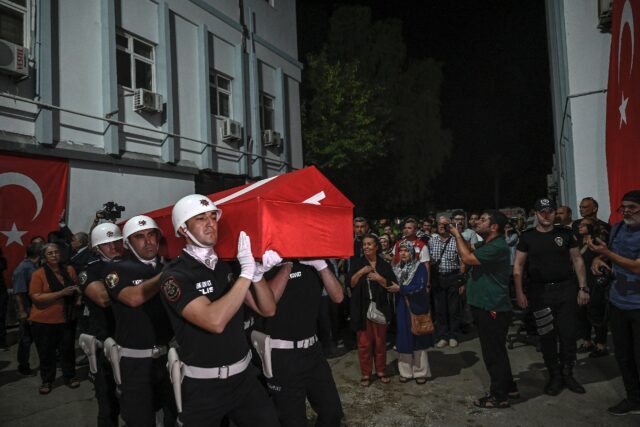 An honour guard carries the coffin of activist Aysenur Ezgi Eygi, who was killed in the We