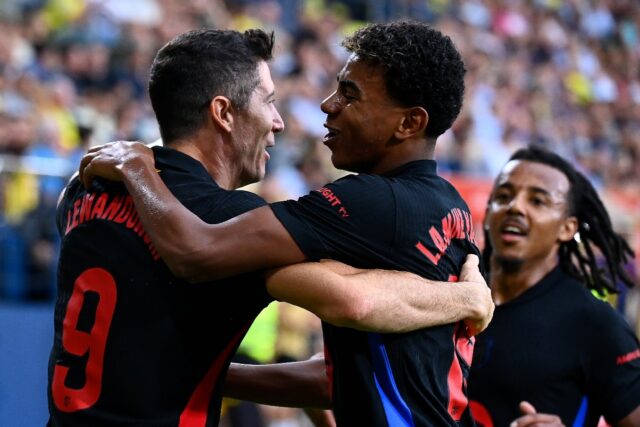 Barcelona's Polish forward Robert Lewandowski celebrates with Lamine Yamal