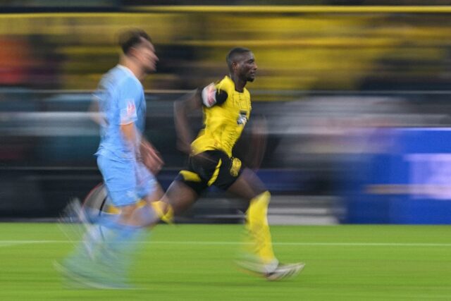 Borussia Dortmund forward Serhou Guirassy (in yellow) scored two goals in a 4-2 win over B