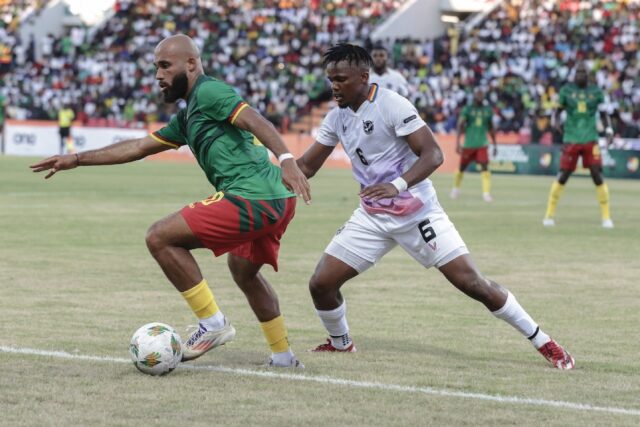 Cameroon forward Bryan Mbeumo (L) shields the ball from Namibia defender Ngero Katua durin