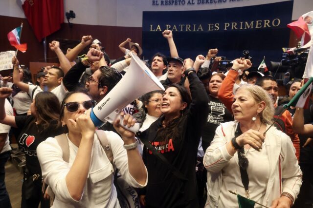 Demonstrators are seen inside Mexico's Senate after storming the building on September 10