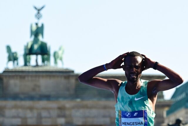 Ethiopia's Milkesa Mengesha reacts after crossing the finish line to win the 50th edition