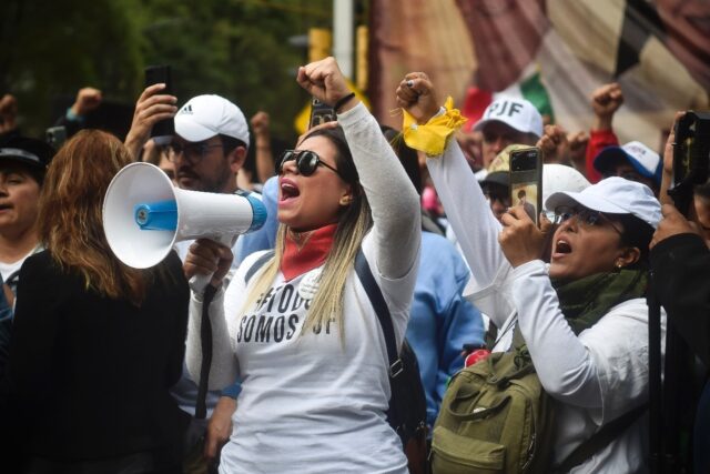 Opponents of Mexico's controversial judicial reforms protest outside the Senate after the