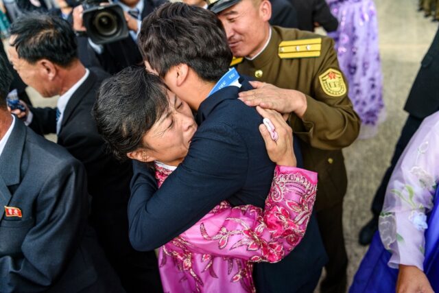 The players were greeted by their families at the airport in Pyongyang, many overcome wit