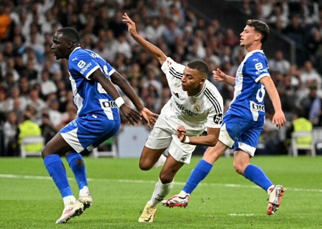 Real Madrid's French striker Kylian Mbappe (C) celebrates scoring his team's second goal a