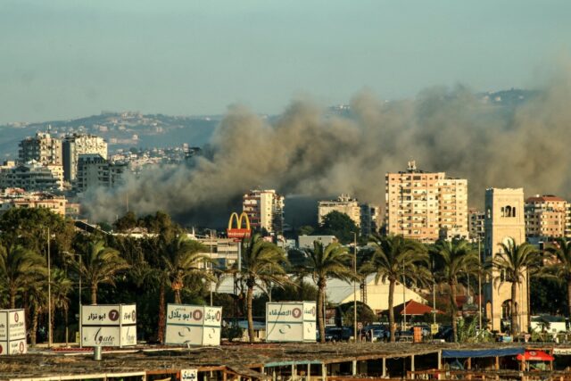 Smoke billows from the site of an Israeli air strike on the area of Burj al-Shamali near t