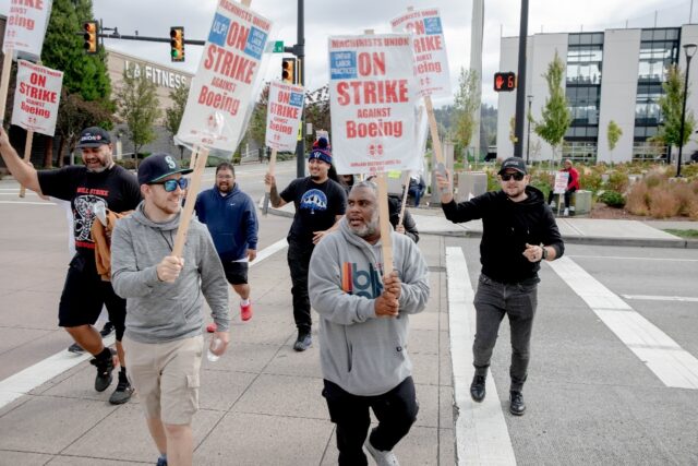 Striking Boeing workers and their supporters picket outside the Boeing Co. manufacturing f