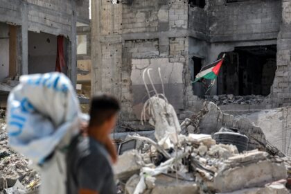 A tattered Palestinian flag flying in a ruined building in southern Gaza's Khan Yunis, nea