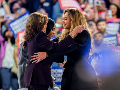 US Vice President Kamala Harris, left, greets singer Beyonce Knowles-Carter, right, and mu