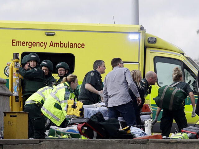 Emergency services staff provide medical attention close to the Houses of Parliament in Lo